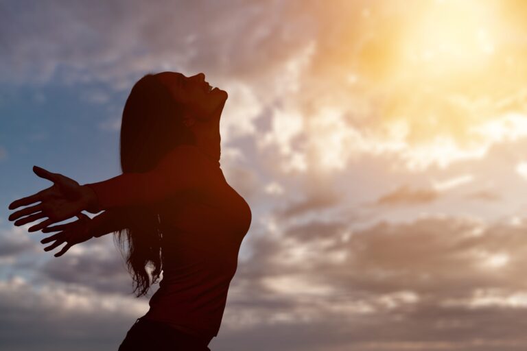 Young woman looking up feeling energized by the warm rays and sky Young woman looking up feeling energized by the warm rays and sky