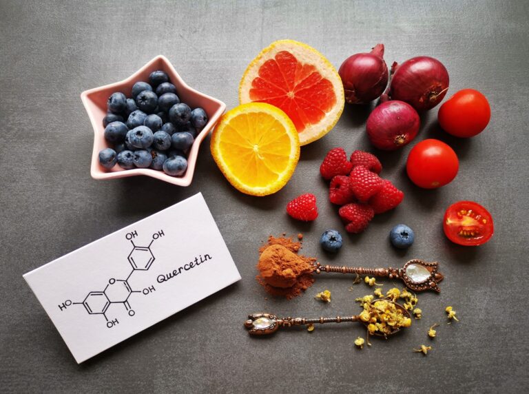 Structural chemical formula of quercetin molecule with fresh fruit and vegetable. Quercetin is a plant pigment (flavonoid). It's found in many plants and foods such as red onions, berries, tomatoes...